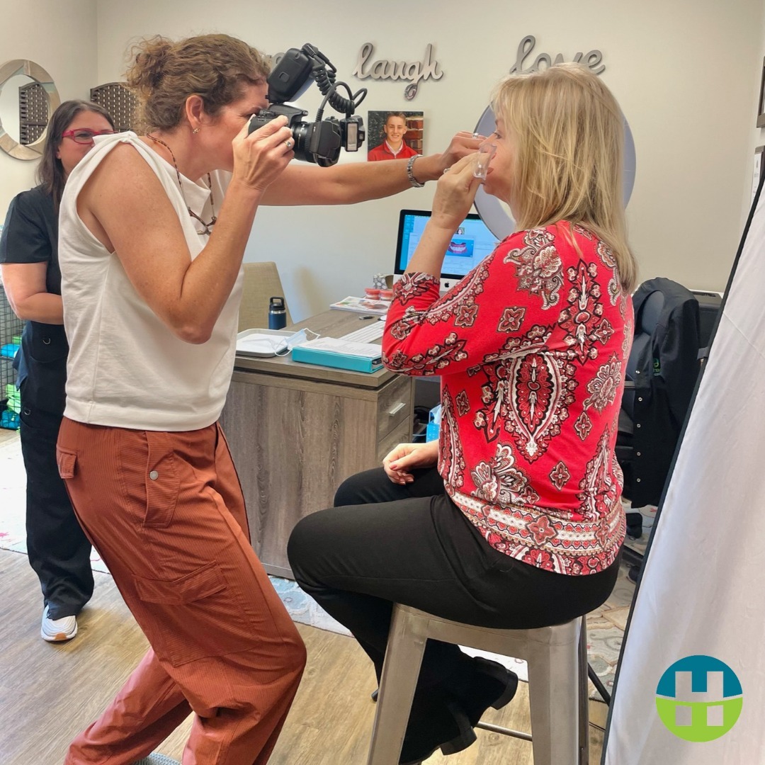 Adult patient having Invisalign treatment progress photos taken with a cheek retractor at Hamada Orthodontics in the New Orleans area